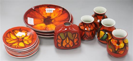Three Poole pottery red ground dishes, seven smaller dishes and five assorted vases